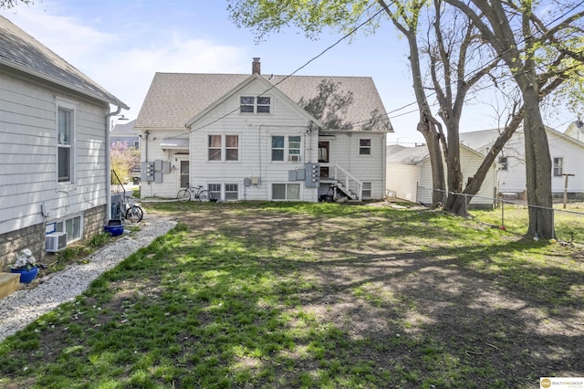 733 N H St, Fremont, NE 68025 - rear view of house with a chimney and roof with shingles