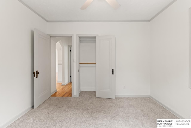 2035 N 50th St, Omaha, NE 68104 - unfurnished bedroom featuring carpet, ornamental molding, arched walkways, ceiling fan, and a closet