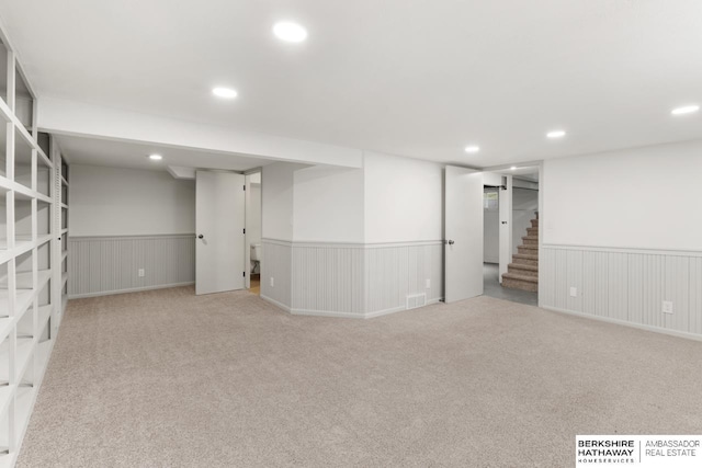 2035 N 50th St, Omaha, NE 68104 - finished basement featuring carpet floors, a wainscoted wall, stairs, and recessed lighting