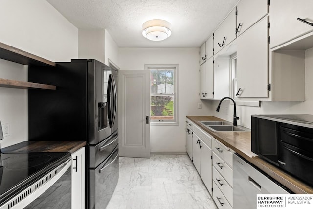 2035 N 50th St, Omaha, NE 68104 - kitchen with a sink, electric range, light marble finish flooring, white cabinets, and a textured ceiling