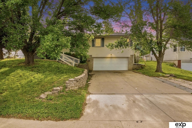 813 Janes View St, Papillion, NE 68046 - view of front facade with an attached garage, a yard, concrete driveway, and brick siding