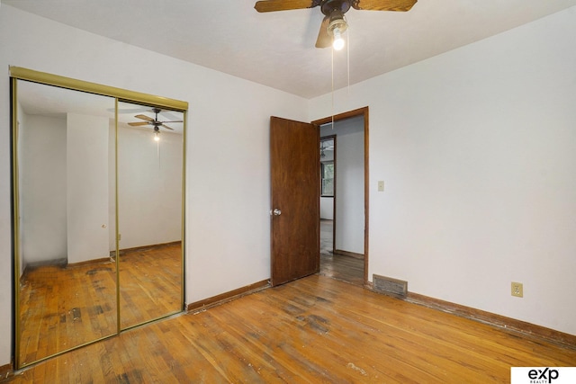 813 Janes View St, Papillion, NE 68046 - unfurnished bedroom featuring wood-type flooring, a closet, baseboards, and a ceiling fan