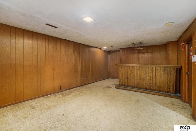 813 Janes View St, Papillion, NE 68046 - finished basement with wood walls, tile patterned floors, and a bar
