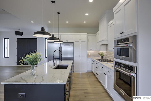 5717 S 200th Cir, Omaha, NE 68135 - kitchen with a sink, recessed lighting, decorative backsplash, light wood-style flooring, and stainless steel appliances