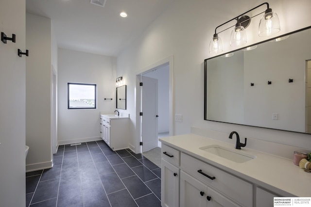 5717 S 200th Cir, Omaha, NE 68135 - full bathroom with two vanities, baseboards, recessed lighting, and tile patterned floors
