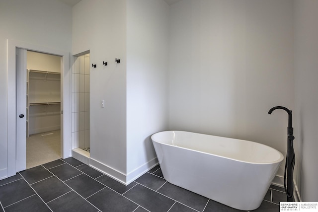 5717 S 200th Cir, Omaha, NE 68135 - bathroom with baseboards, a freestanding bath, a stall shower, tile patterned floors, and a spacious closet