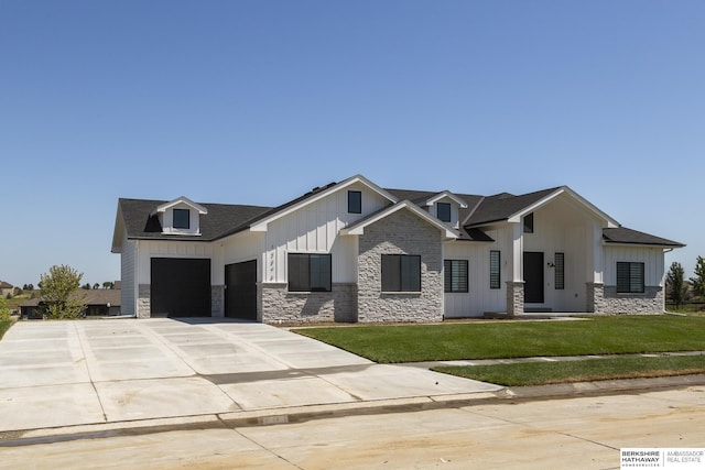 5717 S 200th Cir, Omaha, NE 68135 - modern farmhouse style home with stone siding, board and batten siding, an attached garage, concrete driveway, and a front lawn