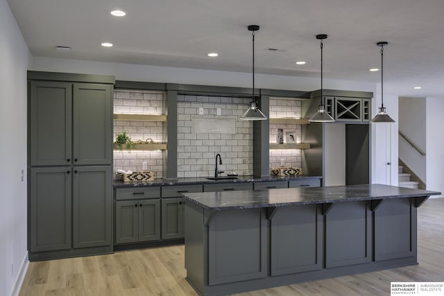 5717 S 200th Cir, Omaha, NE 68135 - kitchen featuring a sink, a center island, decorative backsplash, light wood-type flooring, and recessed lighting