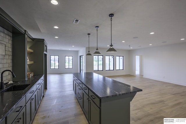 5717 S 200th Cir, Omaha, NE 68135 - kitchen with a sink, open floor plan, recessed lighting, light wood-type flooring, and a kitchen island