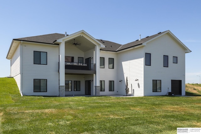 5717 S 200th Cir, Omaha, NE 68135 - back of property with a balcony, ceiling fan, a lawn, and roof with shingles