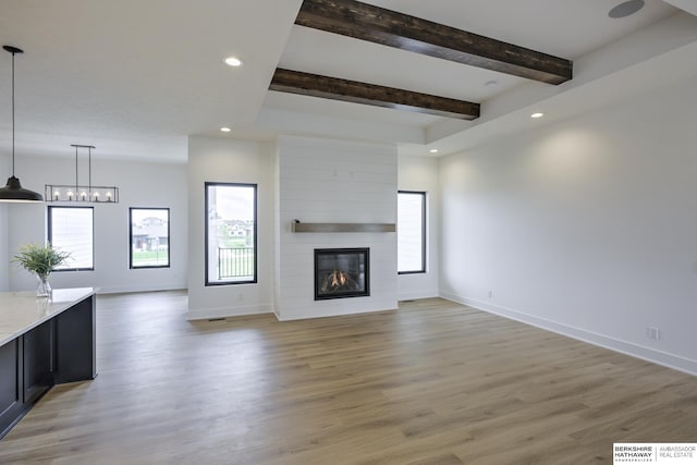 5717 S 200th Cir, Omaha, NE 68135 - unfurnished living room with recessed lighting, baseboards, beam ceiling, light wood-type flooring, and a large fireplace