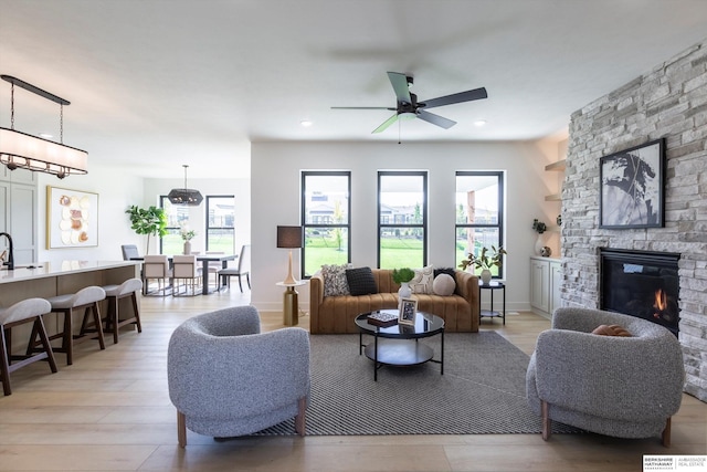 6617 S 214th St, Omaha, NE 68022 - living area featuring a ceiling fan, light wood finished floors, a stone fireplace, and recessed lighting