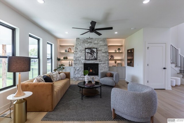 6617 S 214th St, Omaha, NE 68022 - living room featuring a ceiling fan, light wood finished floors, stairs, a stone fireplace, and recessed lighting