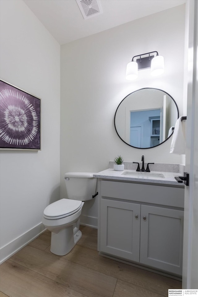 6617 S 214th St, Omaha, NE 68022 - bathroom featuring vanity, baseboards, toilet, and wood finished floors