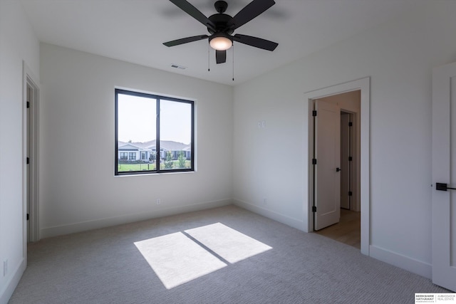 6617 S 214th St, Omaha, NE 68022 - unfurnished bedroom featuring light colored carpet, baseboards, and a ceiling fan