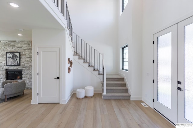 6617 S 214th St, Omaha, NE 68022 - entrance foyer featuring light wood-style floors, stairway, a fireplace, french doors, and baseboards