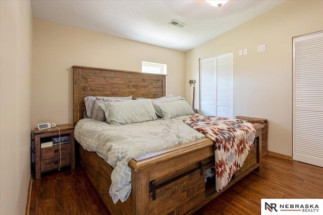 210 4th St, Ithaca, NE 68033 - bedroom featuring vaulted ceiling, wood finished floors, two closets, and baseboards
