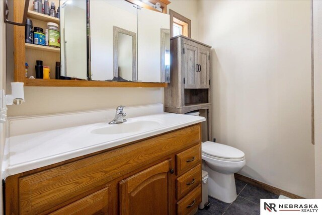 210 4th St, Ithaca, NE 68033 - half bathroom with vanity, toilet, and tile patterned flooring