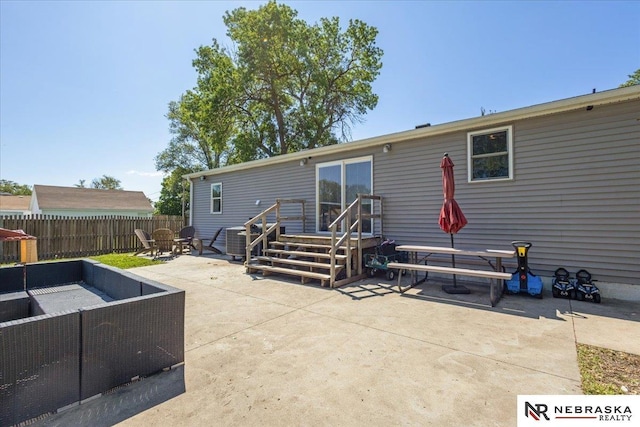 210 4th St, Ithaca, NE 68033 - back of property with a patio, an outdoor hangout area, and central air condition unit