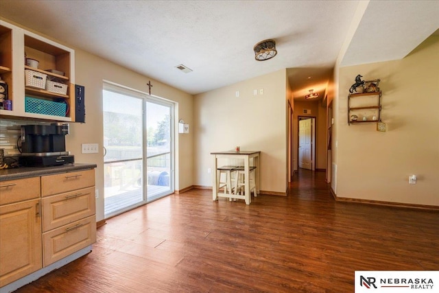 210 4th St, Ithaca, NE 68033 - kitchen with dark wood-type flooring, dark countertops, decorative backsplash, and baseboards