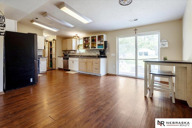 210 4th St, Ithaca, NE 68033 - kitchen featuring stainless steel appliances, dark wood-style flooring, tasteful backsplash, open shelves, and dark countertops