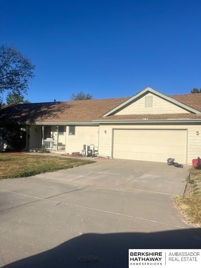 15911 S 234th St, Gretna, NE 68028 - ranch-style home featuring a garage, concrete driveway, and a porch