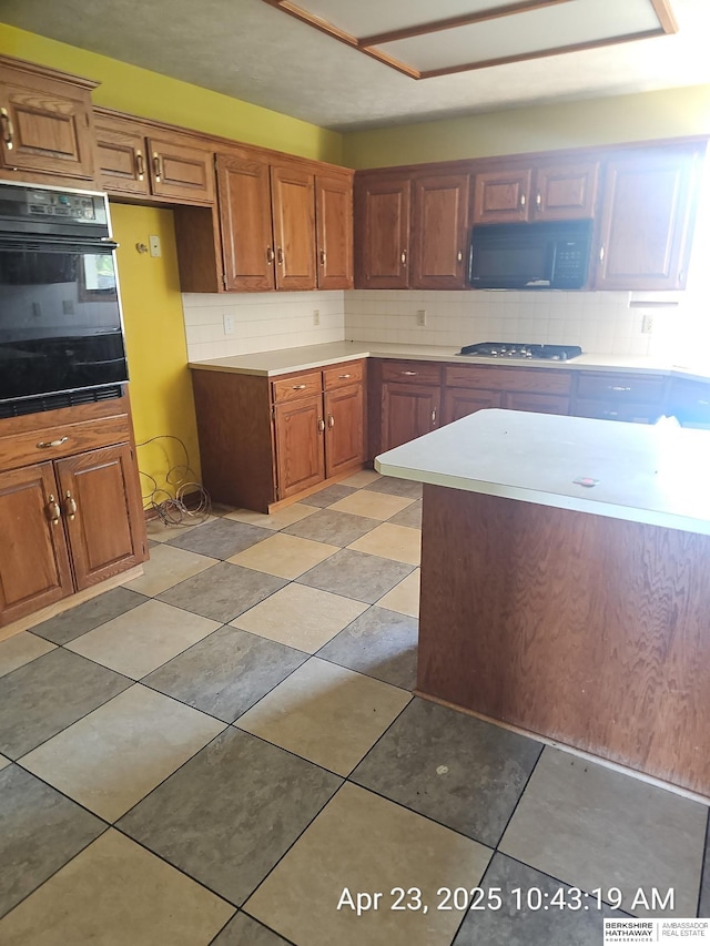 15911 S 234th St, Gretna, NE 68028 - kitchen featuring oven, brown cabinets, and decorative backsplash