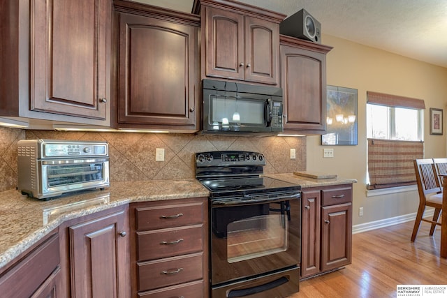 18855 Mason Plz, Omaha, NE 68022 - kitchen featuring black appliances, light wood-style floors, baseboards, light stone counters, and tasteful backsplash