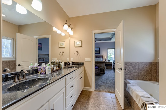 18855 Mason Plz, Omaha, NE 68022 - ensuite bathroom featuring double vanity, a jetted tub, tile patterned floors, and baseboards
