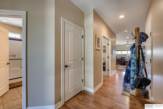 18855 Mason Plz, Omaha, NE 68022 - hallway featuring plenty of natural light, baseboards, recessed lighting, and light wood finished floors