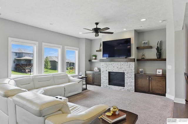 20956 Pine Cir, Elkhorn, NE 68022 - living room with ceiling fan, a stone fireplace, recessed lighting, wood finished floors, and baseboards