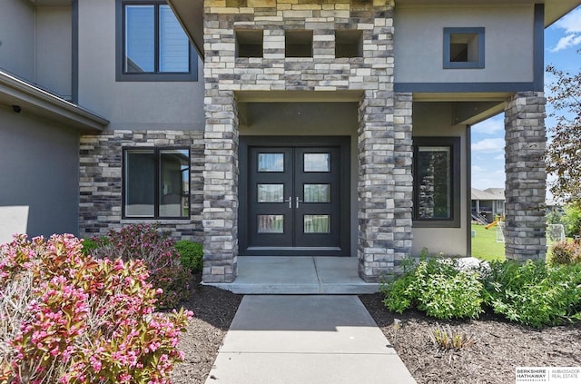 20956 Pine Cir, Elkhorn, NE 68022 - property entrance with stucco siding, stone siding, and french doors