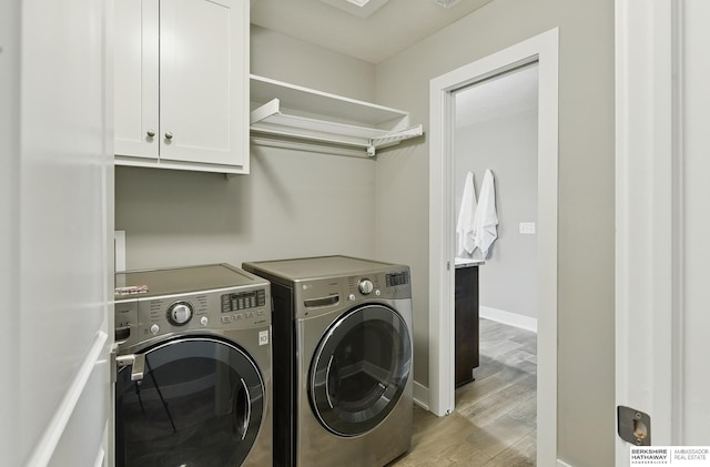 20956 Pine Cir, Elkhorn, NE 68022 - washroom featuring cabinet space, washing machine and clothes dryer, light wood-style floors, and baseboards