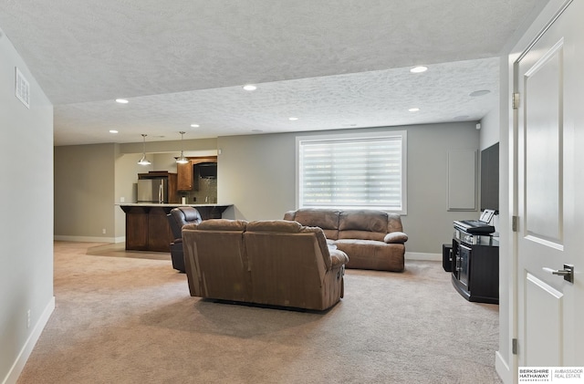 20956 Pine Cir, Elkhorn, NE 68022 - living area featuring light colored carpet, baseboards, a textured ceiling, and recessed lighting