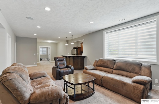 20956 Pine Cir, Elkhorn, NE 68022 - living area with light colored carpet, baseboards, recessed lighting, and a textured ceiling