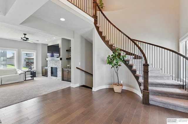 20956 Pine Cir, Elkhorn, NE 68022 - staircase with wood finished floors, a ceiling fan, baseboards, recessed lighting, and a high ceiling