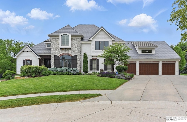 2025 S 189th Cir, Omaha, NE 68130 - french country inspired facade featuring a front yard, concrete driveway, stone siding, and a garage