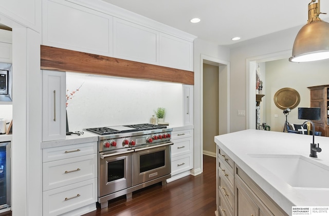 2025 S 189th Cir, Omaha, NE 68130 - kitchen with double oven range, dark wood-style floors, a sink, light countertops, and recessed lighting