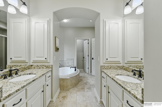 2025 S 189th Cir, Omaha, NE 68130 - bathroom with two vanities, a garden tub, and baseboards