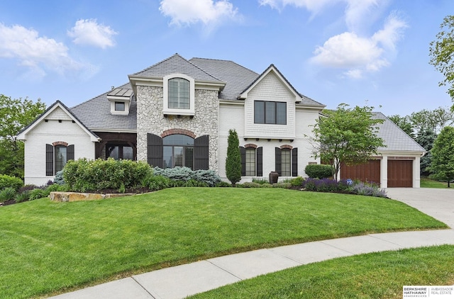 2025 S 189th Cir, Omaha, NE 68130 - french country inspired facade with driveway, a front lawn, a garage, and stone siding