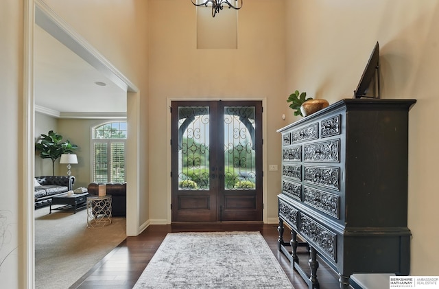 2025 S 189th Cir, Omaha, NE 68130 - entryway featuring dark wood-type flooring, french doors, baseboards, ornamental molding, and a chandelier