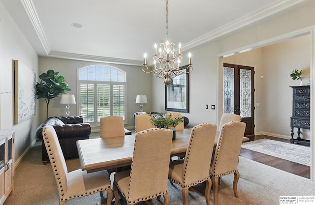 2025 S 189th Cir, Omaha, NE 68130 - dining room featuring crown molding, a chandelier, baseboards, and wood finished floors