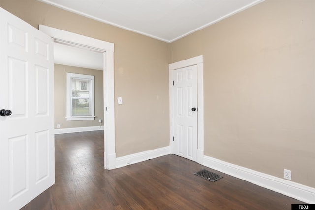 6935 Binney St, Omaha, NE 68104 - spare room featuring dark wood-style floors, crown molding, and baseboards