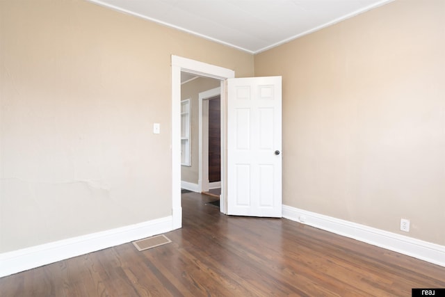 6935 Binney St, Omaha, NE 68104 - empty room with baseboards, dark wood finished floors, and ornamental molding