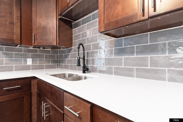 6935 Binney St, Omaha, NE 68104 - kitchen with a sink, tasteful backsplash, and light countertops