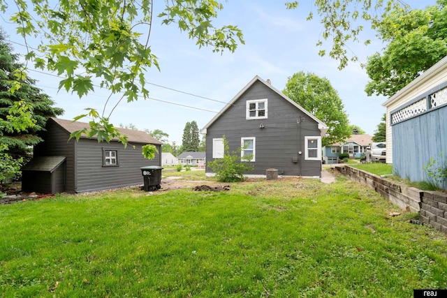 6935 Binney St, Omaha, NE 68104 - back of house with a lawn and an outbuilding