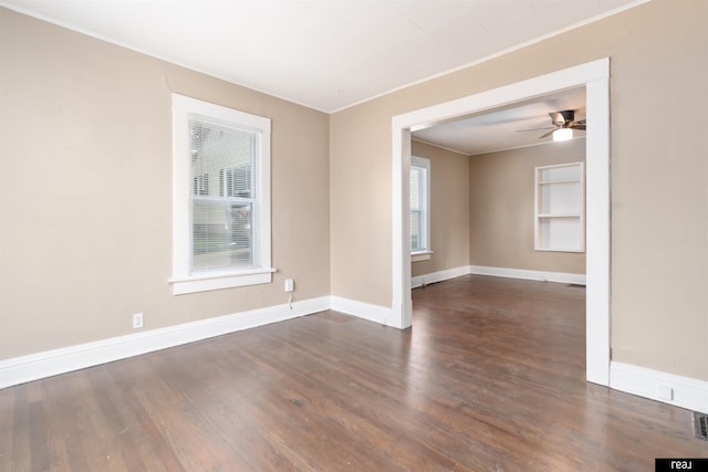 6935 Binney St, Omaha, NE 68104 - spare room with ornamental molding, healthy amount of natural light, dark wood-style flooring, baseboards, and ceiling fan