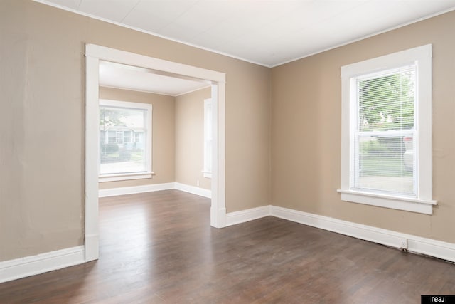 6935 Binney St, Omaha, NE 68104 - spare room with ornamental molding, healthy amount of natural light, dark wood-type flooring, and baseboards