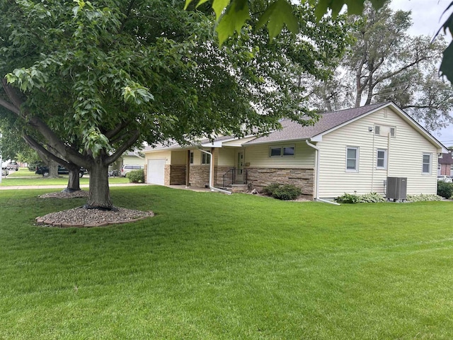 2417 Fairway Dr, Fremont, NE 68025 - view of front of property with an attached garage, a front yard, central AC, and stone siding