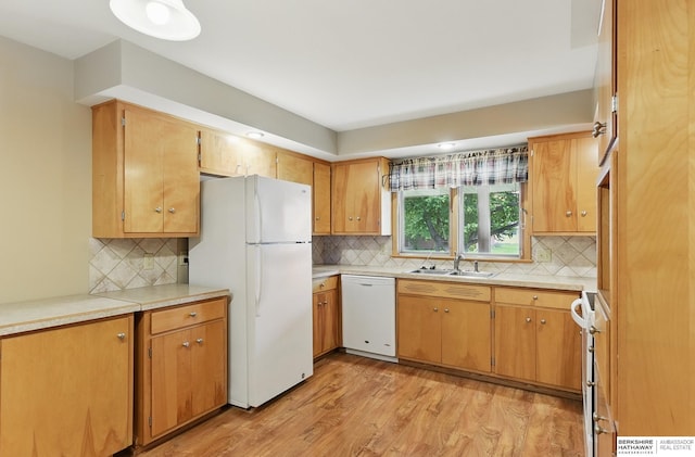 2417 Fairway Dr, Fremont, NE 68025 - kitchen with white appliances, light wood-style floors, backsplash, a sink, and light countertops